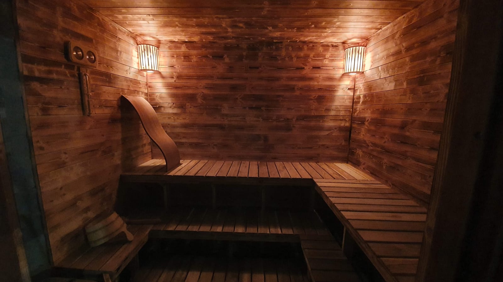 Inside that first build — the benches, panelling and warm lamplight Petteri still enjoys today.